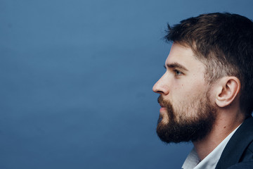 Fototapeta premium Business man with a beard on a blue background, portrait