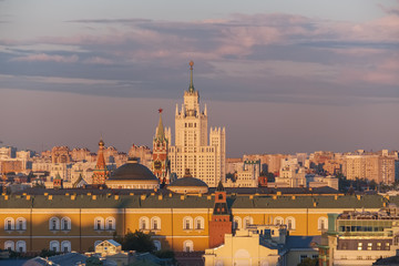 City landscape Moscow at sunset. Soviet skyscraper on the Kotelnicheskaya embankment, the tower, the dome and the construction of the Kremlin