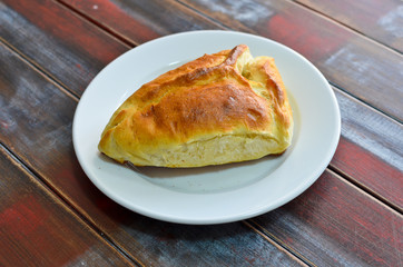 Traditional georgian food samsa on wooden painted background