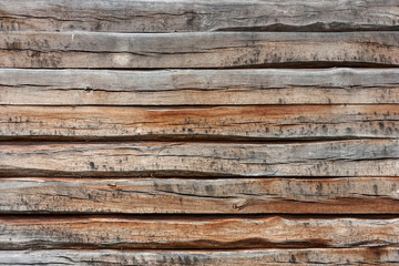 Brown background texture of horizontal wooden planks logs bark.