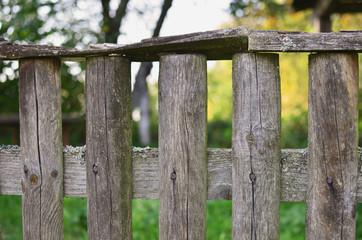 Close up view of old wooden fence in the garden. Copy space.