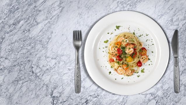 Spaghetti With Shrimps Or Prawns Dish On Marble Countertop With Copyspace On Side. Top View