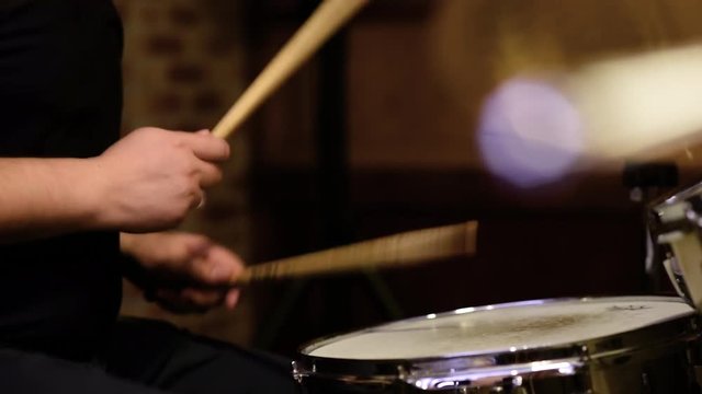 Drummer hands detail playing rock music rhythm with drumstick