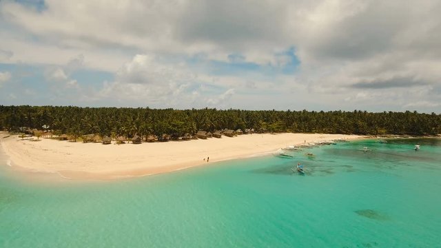 Aerial view of beautiful tropical island Daco with white sand beach. View of a nice tropical beach from the air. Beautiful sky, sea, resort. Seascape: Ocean and beautiful beach paradise. Philippines