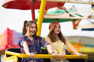 Girlfriends having good time and holding on a roller coaster