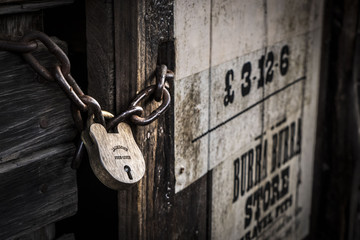 Old rustic padlock, chain and wooden door