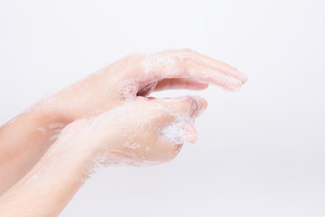 Fototapeta premium Asian girl's hands are washing with soap bubbles.on white background