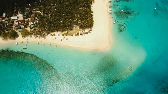 Aerial view of beautiful tropical island Daco with white sand beach. View of a nice tropical beach from the air. Beautiful sea, resort. Seascape: Ocean and beautiful beach paradise. Philippines. 4K