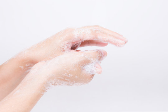 Asian girl's hands are washing with soap bubbles.on white background