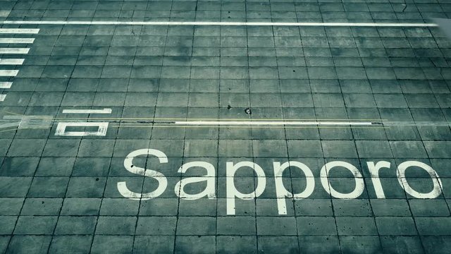 Aerial view of big airplane arriving to Sapporo airport. Travel to Japan conceptual intro animation