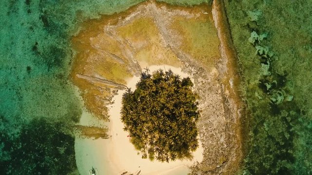 Aerial view of beautiful tropical island Guyam with white sand beach. View of a nice tropical beach from the air. Seascape: Ocean and beautiful beach paradise. Philippines. 4K video. Travel concept