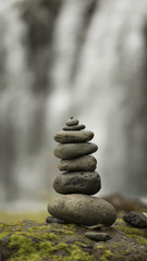 Stack of pebbles and waterfall