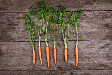 Carrots on wooden plank surface