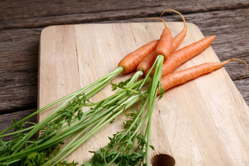 Carrots on wooden chopping board