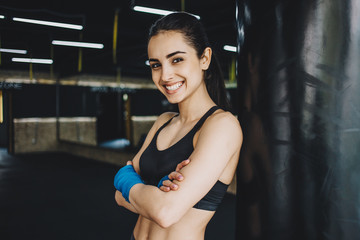 Beautiful and fit female fighter getting prepared for the fight or training