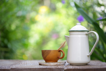 White vintage teapot  and brown cup at out door