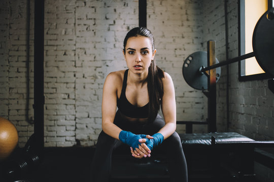 Young woman having some rest after hard workout in gym.