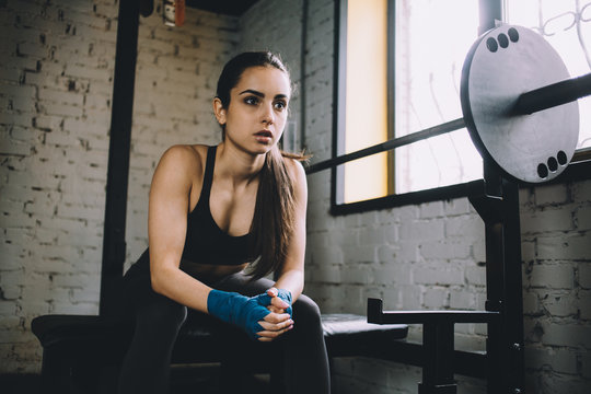 Young woman having some rest after hard workout in gym.