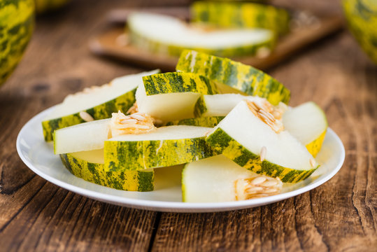 Portion of Fresh Futuro Melon on wooden background (selective focus)