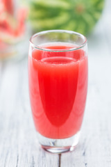 Wooden table with Watermelon Smoothie (selective focus)