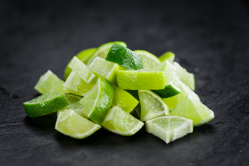 Sliced Limes on a vintage slate slab (selective focus)