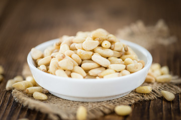 Wooden table with Pine Nuts (selective focus)