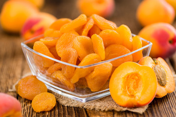 Apricots (dried) on wooden background (selective focus)
