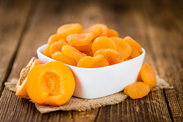 Apricots (dried) on wooden background (selective focus)