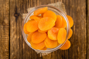 Dried Apricots (selective focus) on vintage wooden background
