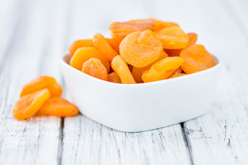 Apricots (dried) on wooden background (selective focus)