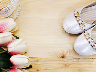 woman flats shoes and tulips flower on wooden background