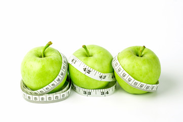 green apple with Measuring tape on white background in concept of healthy and diet