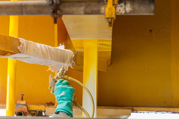 Painted, corroded, anti-corrosion, with spray guns on the production platform to extend the life of materials, Energy and petroleum industry sea offshore