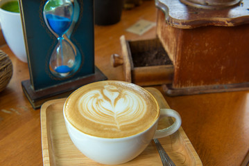 latte art coffee or cappuccino on wooden table background