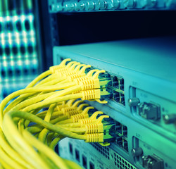 Network cables in switch and firewall in cloud computing data center server rack