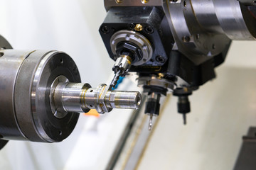 Fototapeta na wymiar machining automotive part by cnc turning machine