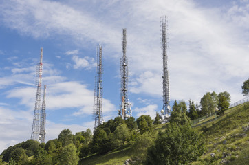 Group of towers for telecommunications on the top of the mountain. Electromagnetic and environmental pollution. Linzone mountain pick. Orobie Prealps. Italy