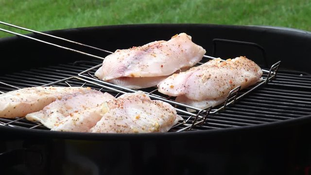 Man's hands cooking fish fillet on grill