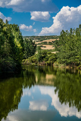 Fototapeta na wymiar Oreokastro Lake under the beautiful sky of Greece, vertical shot