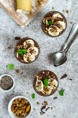 Chocolate pudding with chia and banana in glasses. Healthy dessert or breakfast.