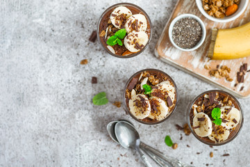Obraz na płótnie Canvas Chocolate pudding with chia and banana in glasses. Healthy dessert or breakfast.