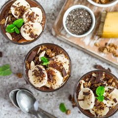 Chocolate pudding with chia and banana in glasses. Healthy dessert or breakfast.