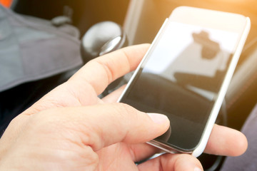 Close-up of female hands using smart phone with flare light background. Searching Internet ,Social Networking Concept
