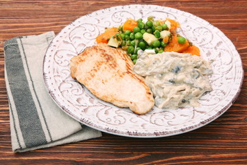 Turkey fillet with mushrooms in cream sauce and vegetables