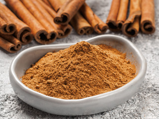 Ground cinnamon on gray background