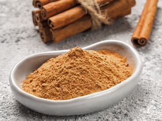 Ground cinnamon on gray background