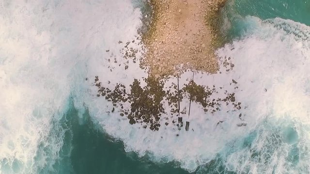 Aerial top view of artificial mound in ocean, spin, Bali