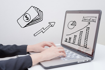 hand use laptop with  rise arrow with graph