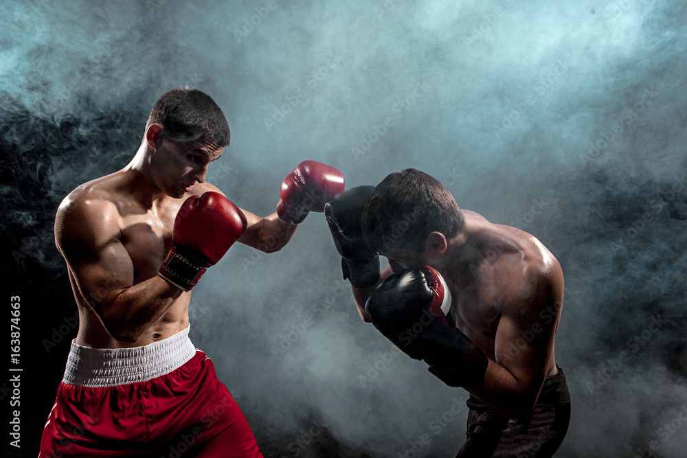 Wall mural two professional boxer boxing on black smoky background,