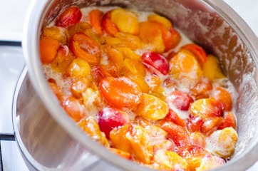 Apricots jam is cooking in a pot
